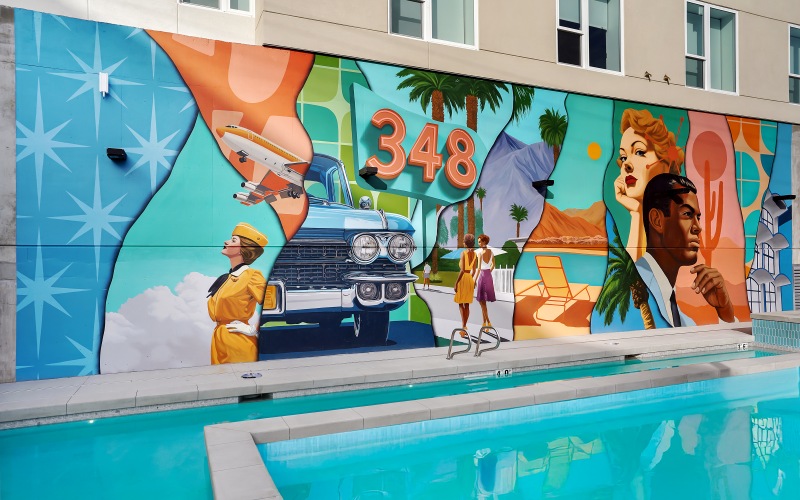 A pool with a wall mural at The Source on South Temple luxury apartments in Salt Lake City, UT.
