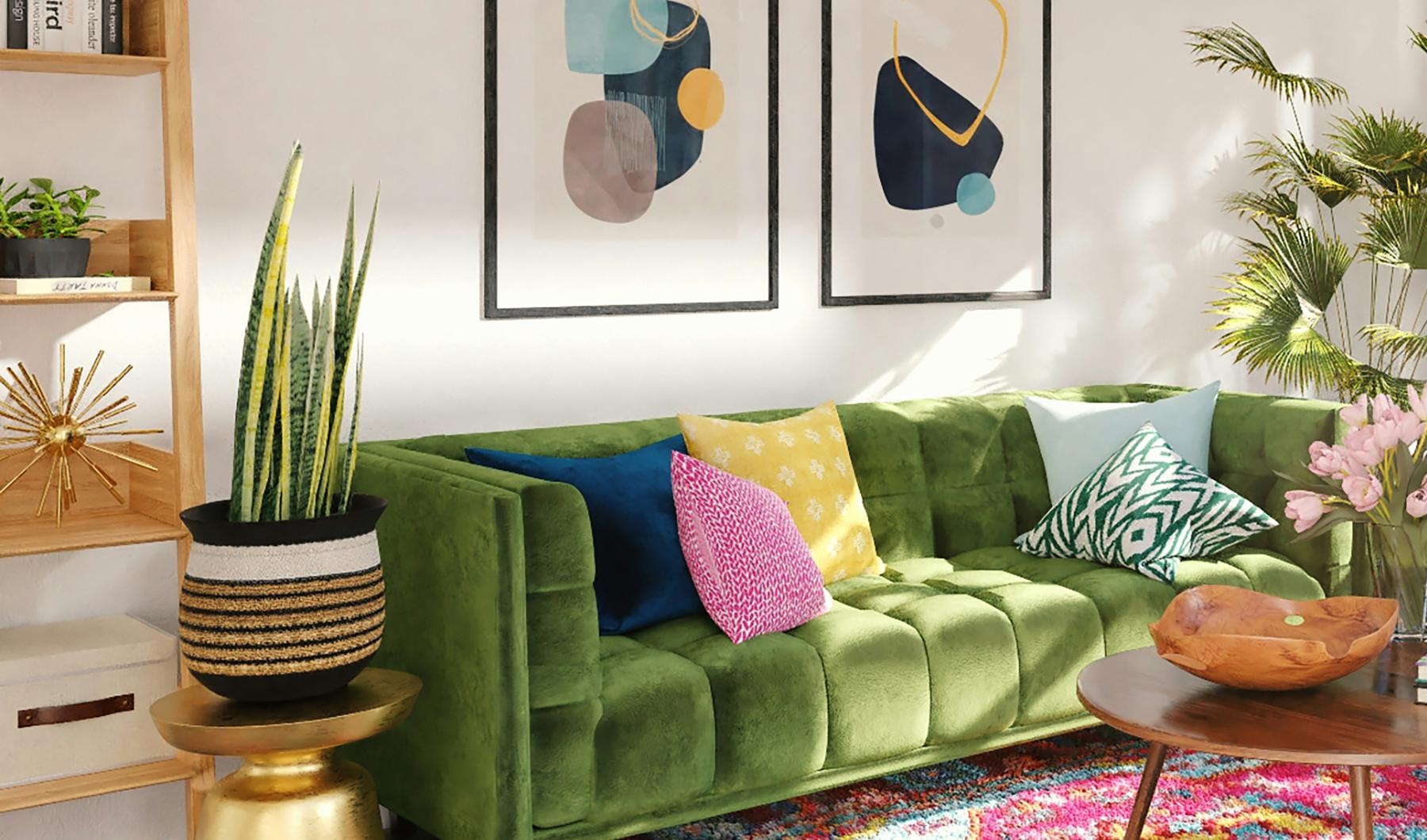 a living room with agreen couch with pillows and side tables